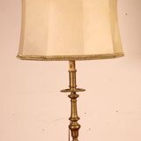 bronze candlestick from the 17th century converted into a lamp with its lampshade
