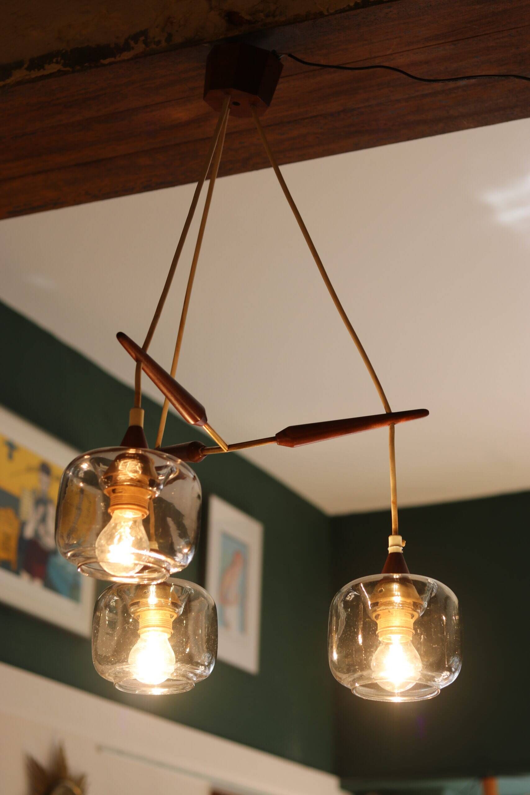 Scandinavian chandelier "Cascade" from the 1960s in brass, teak, and smoked glass.