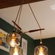 Scandinavian chandelier "Cascade" from the 1960s in brass, teak, and smoked glass.