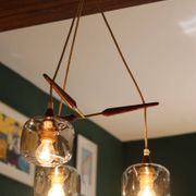 Scandinavian chandelier "Cascade" from the 1960s in brass, teak, and smoked glass.