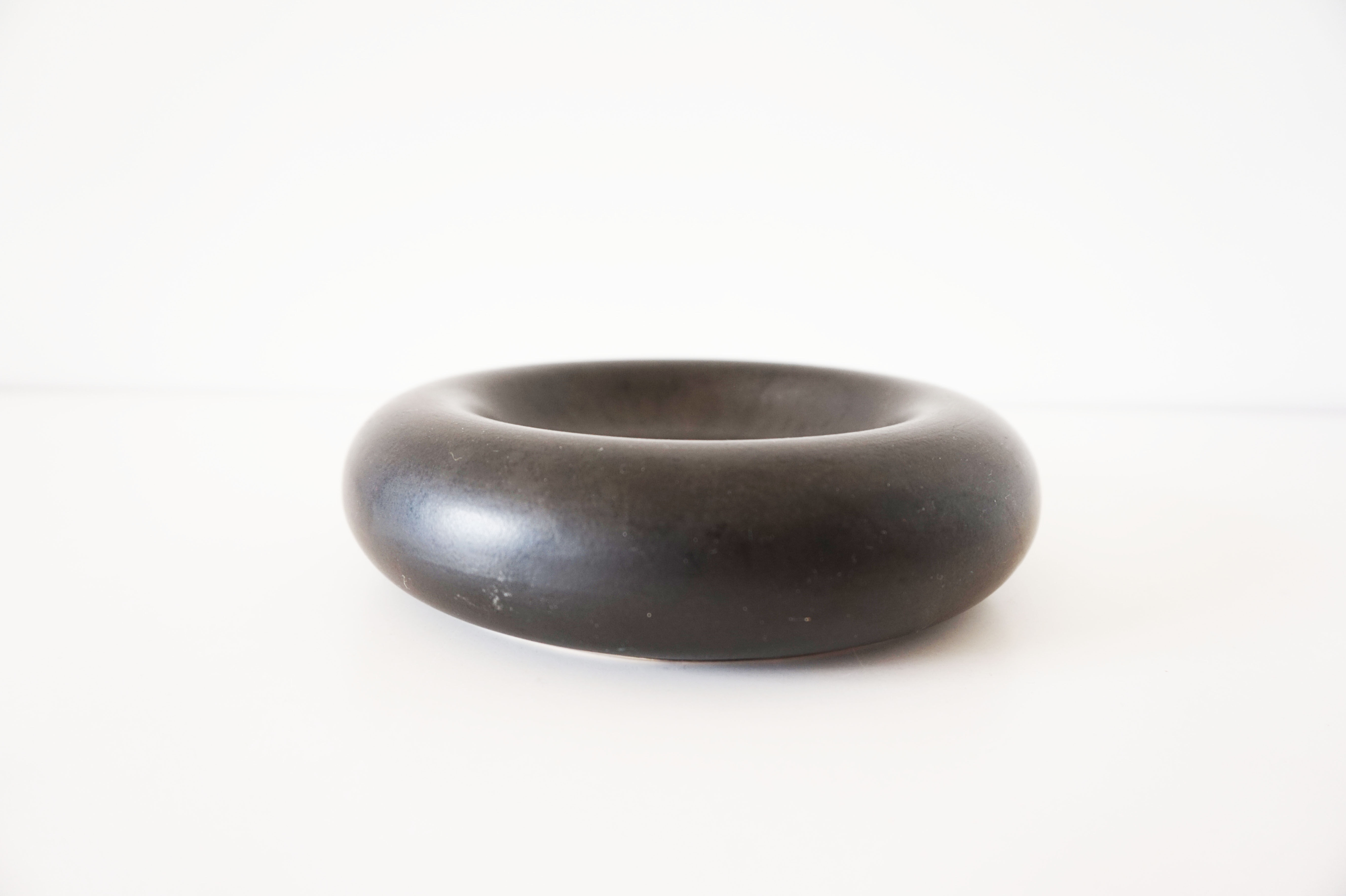 Empty round pocket in black ceramic