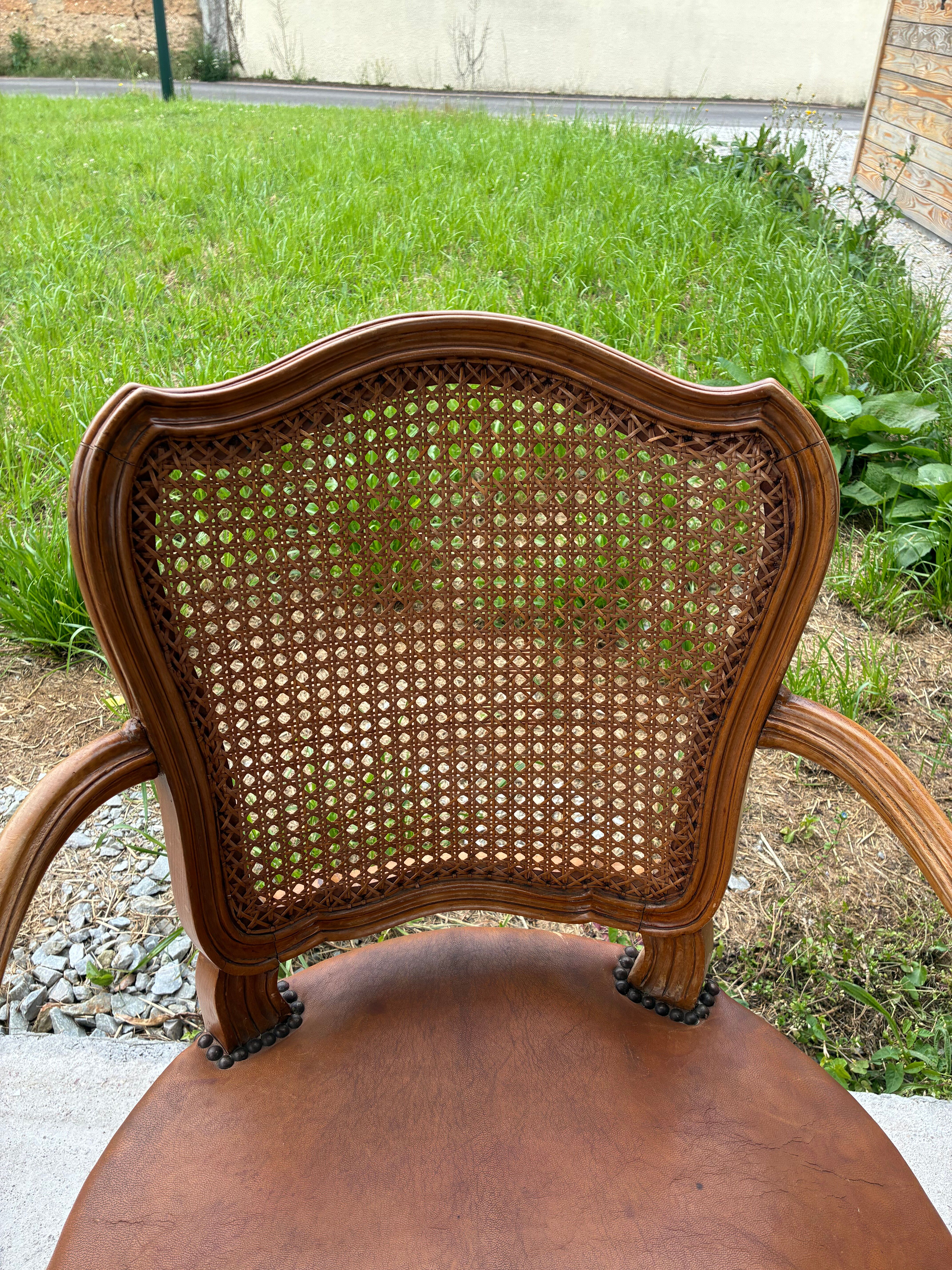 Cane and leather armchair in Louis XV style