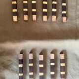 Lot 11 knife rests in ebony and silver-plated metal.