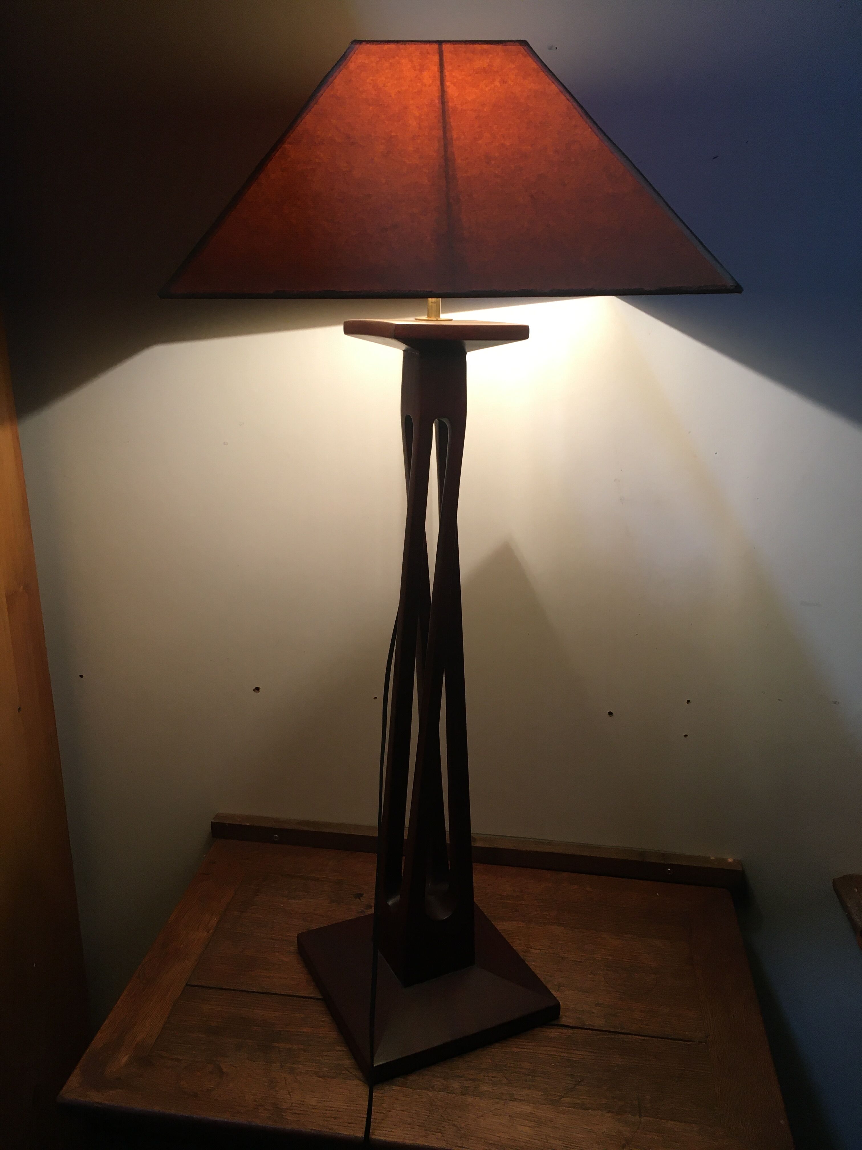 Mahogany lamp with a sculpted base.