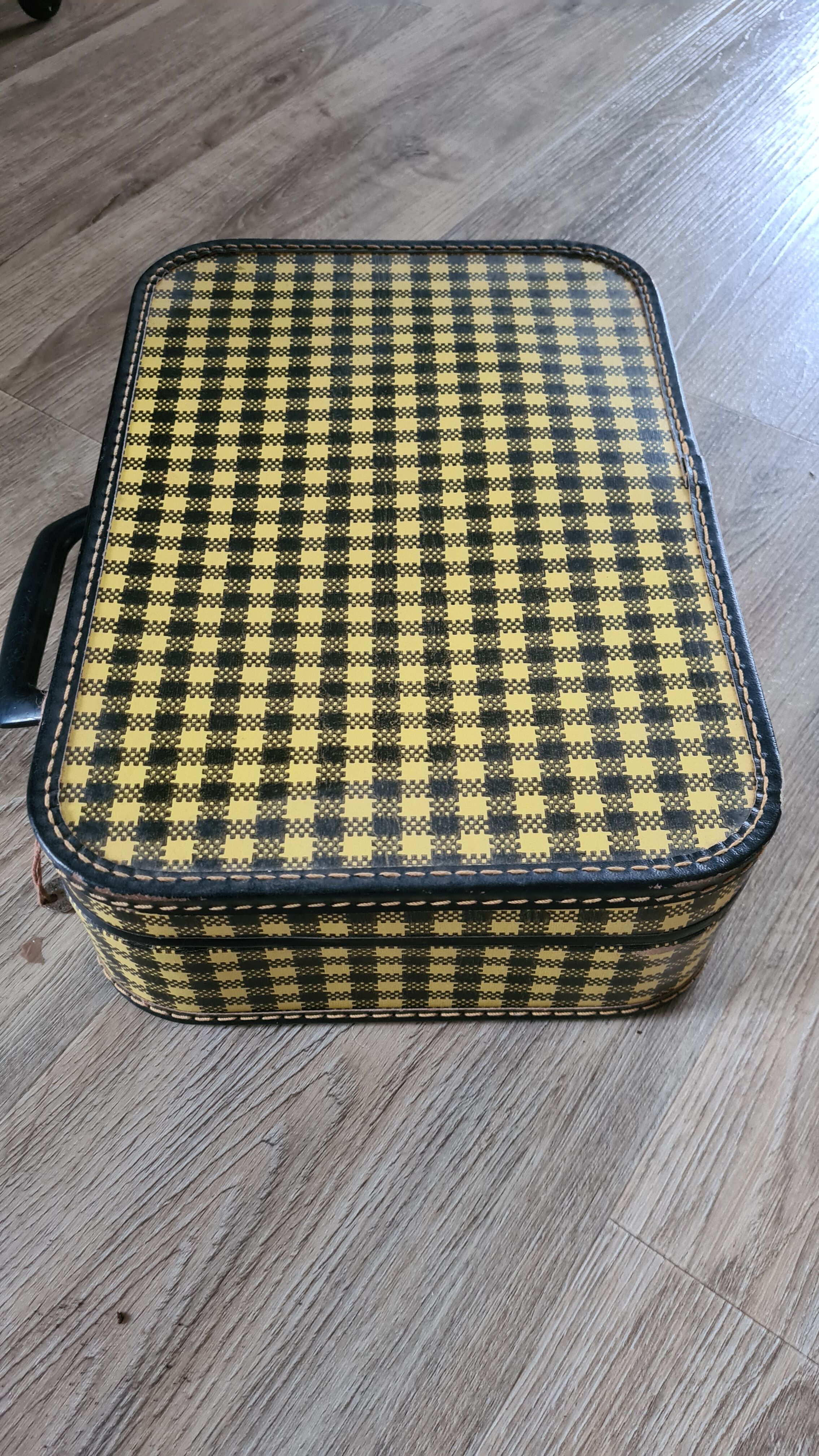 Antique suitcase in vintage yellow and black cardboard