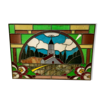 Art Deco stained glass window decorated with a 20th century church steeple