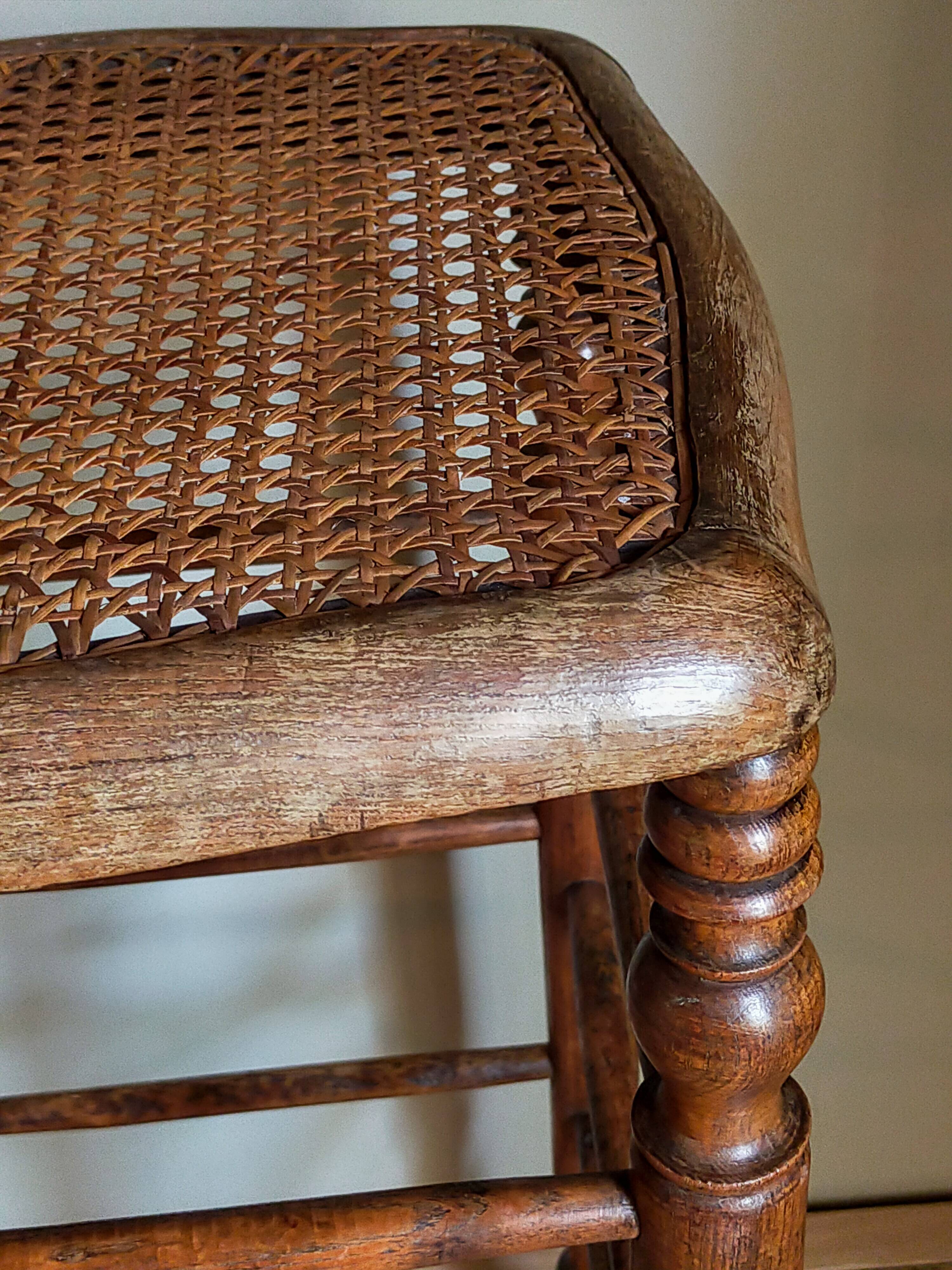 Antique stool with cane and turned wood