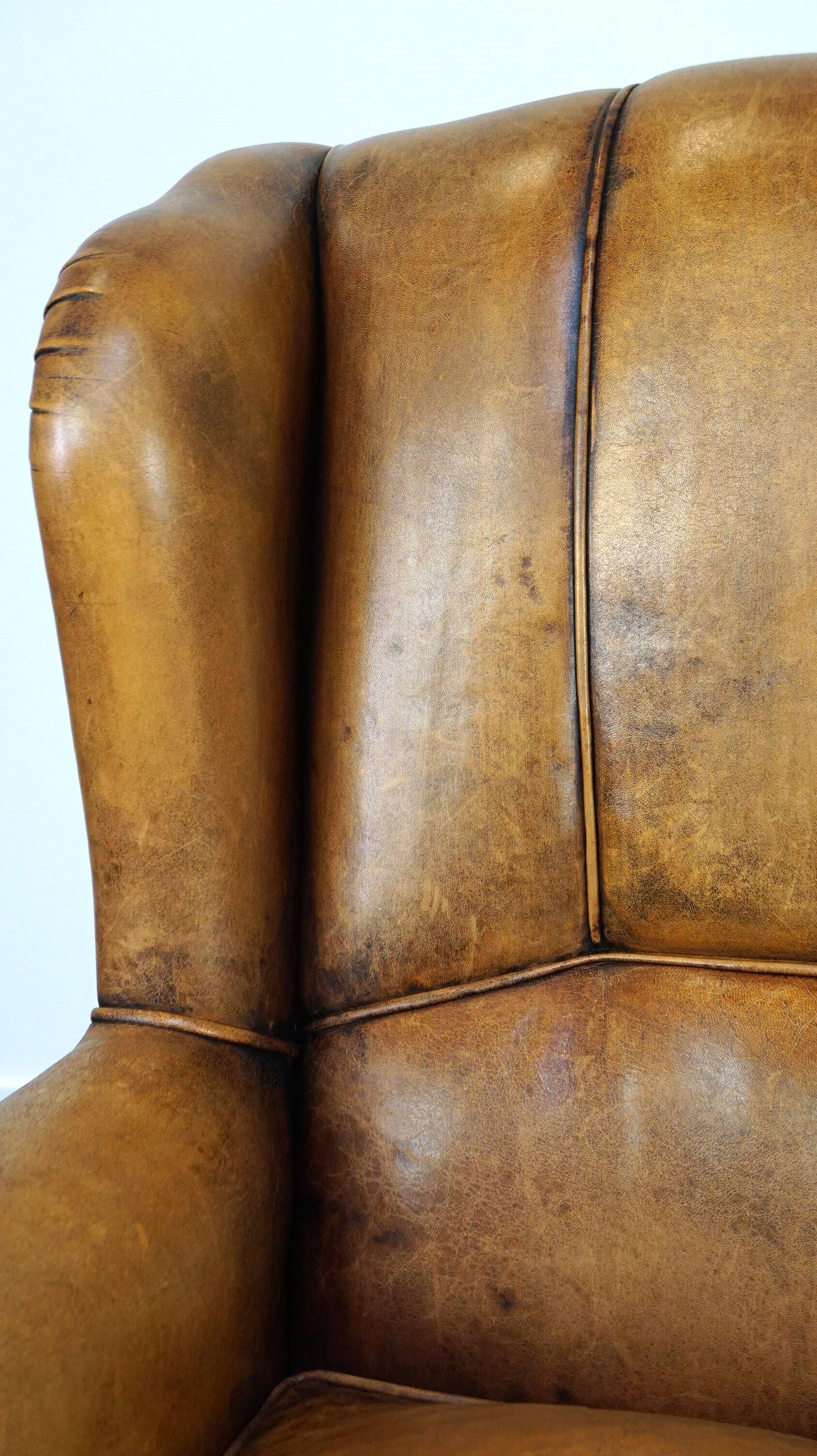 Sheepskin wingback chair with a unique design and a beautiful patina