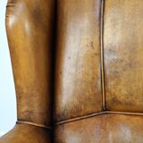 Sheepskin wingback chair with a unique design and a beautiful patina