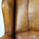 Sheepskin wingback chair with a unique design and a beautiful patina
