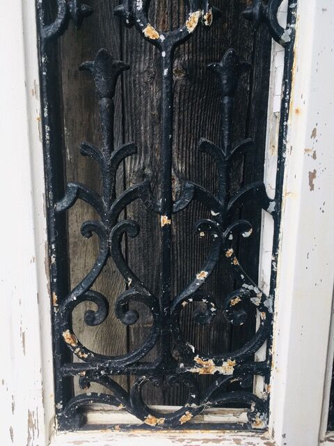 Old door with wrought iron grille