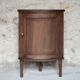 Antique wooden corner cabinet with a curved door.