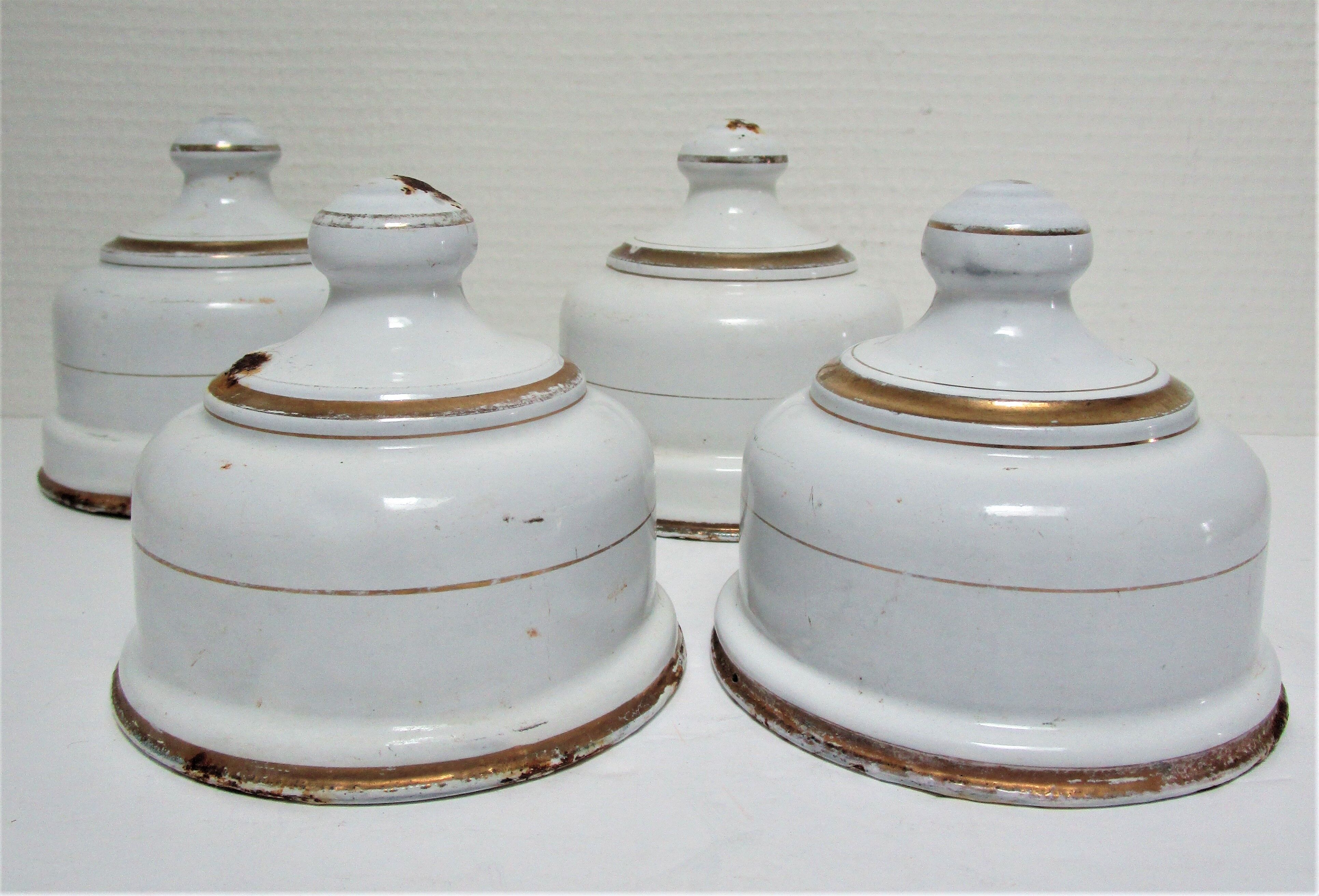 Four white enamelled metal cheese bells early twentieth century