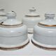 Four white enamelled metal cheese bells early twentieth century