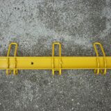 Yellow metal wall coat holder