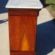 Antique mahogany chest of drawers with white marble.