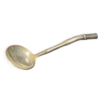 Silver metal sugar spoon.