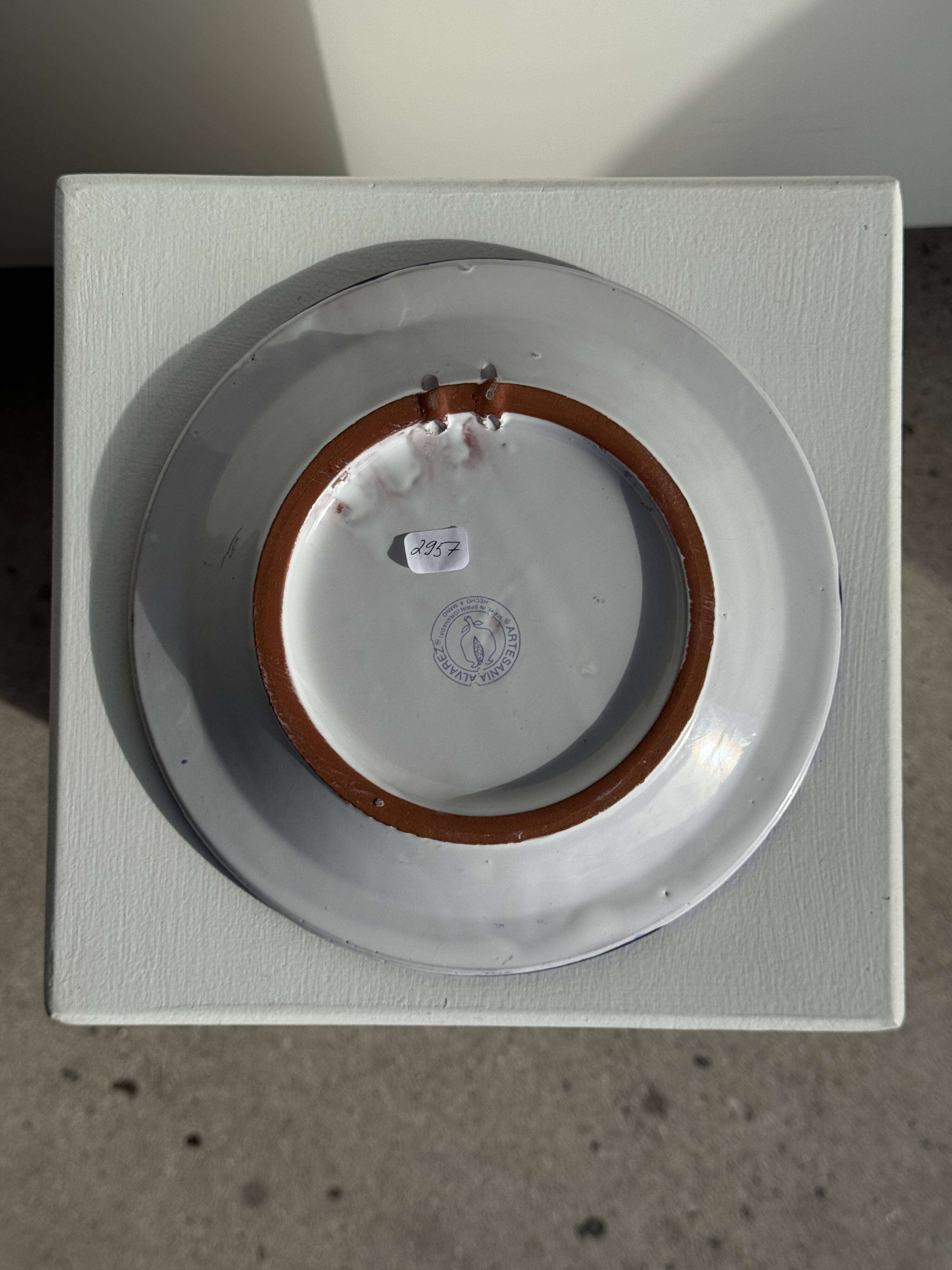 Artesania Alvarez Spanish plate in terracotta with blue plant motif.