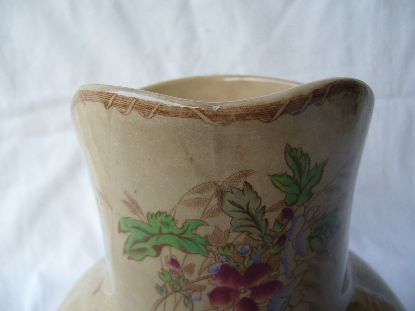 Antique pitcher decorated with flowers