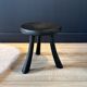 Small black wooden tripod stool