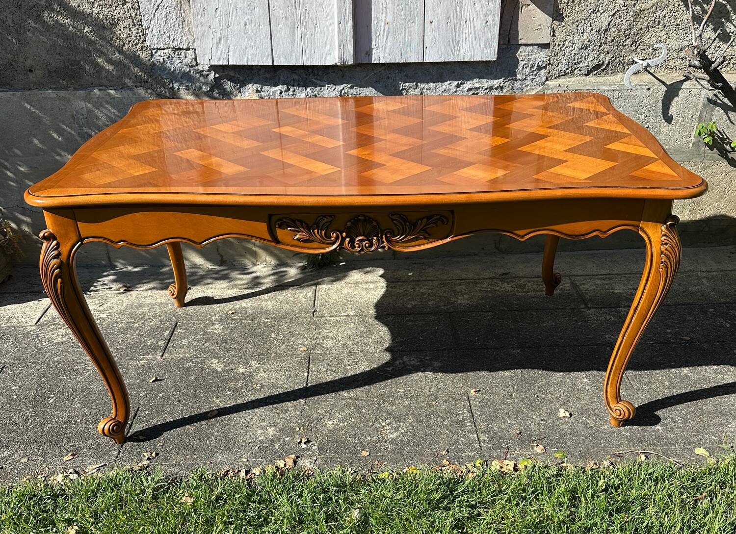 Antique extendable table in cherry wood and marquetry in the Louis XV style.
