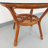 Vintage round smoked glass and rattan coffee table from the 70s