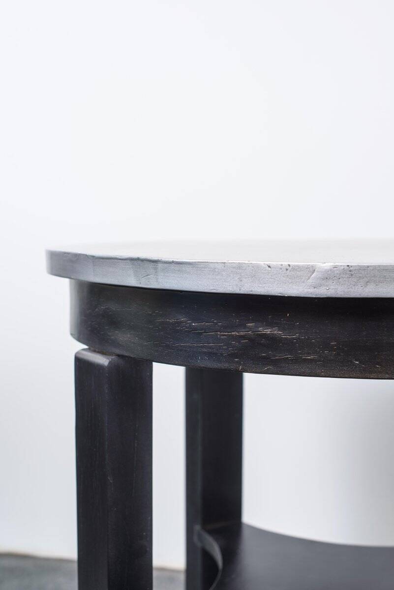 Round Art Deco black painted wooden side table with lower shelf, 1930s.