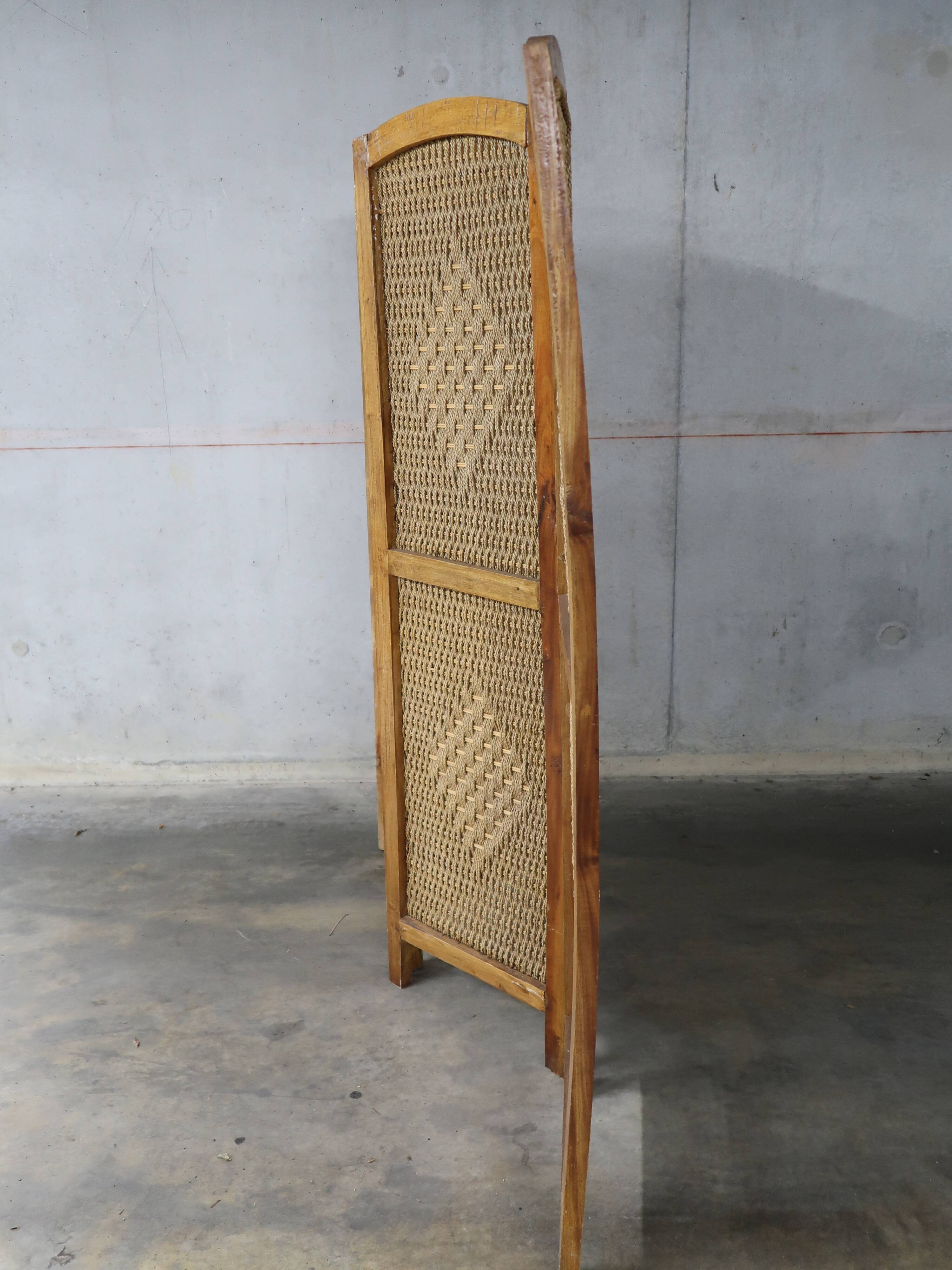 Handcrafted screen in exotic wood and rope.