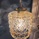 Moulded glass lamp with a cubic-spherical relief design.