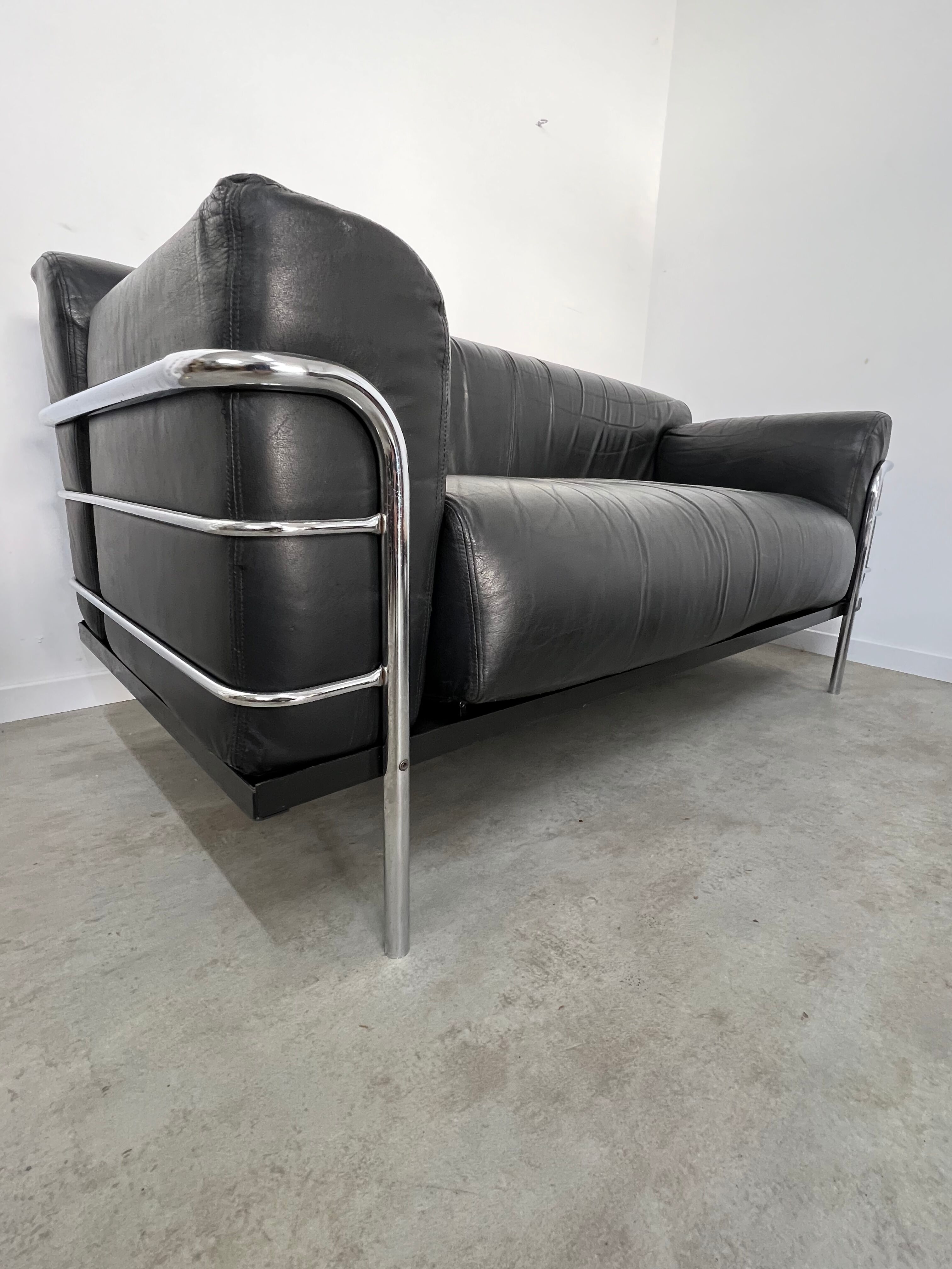 Old vintage leather and tubular metal sofa, design 70s