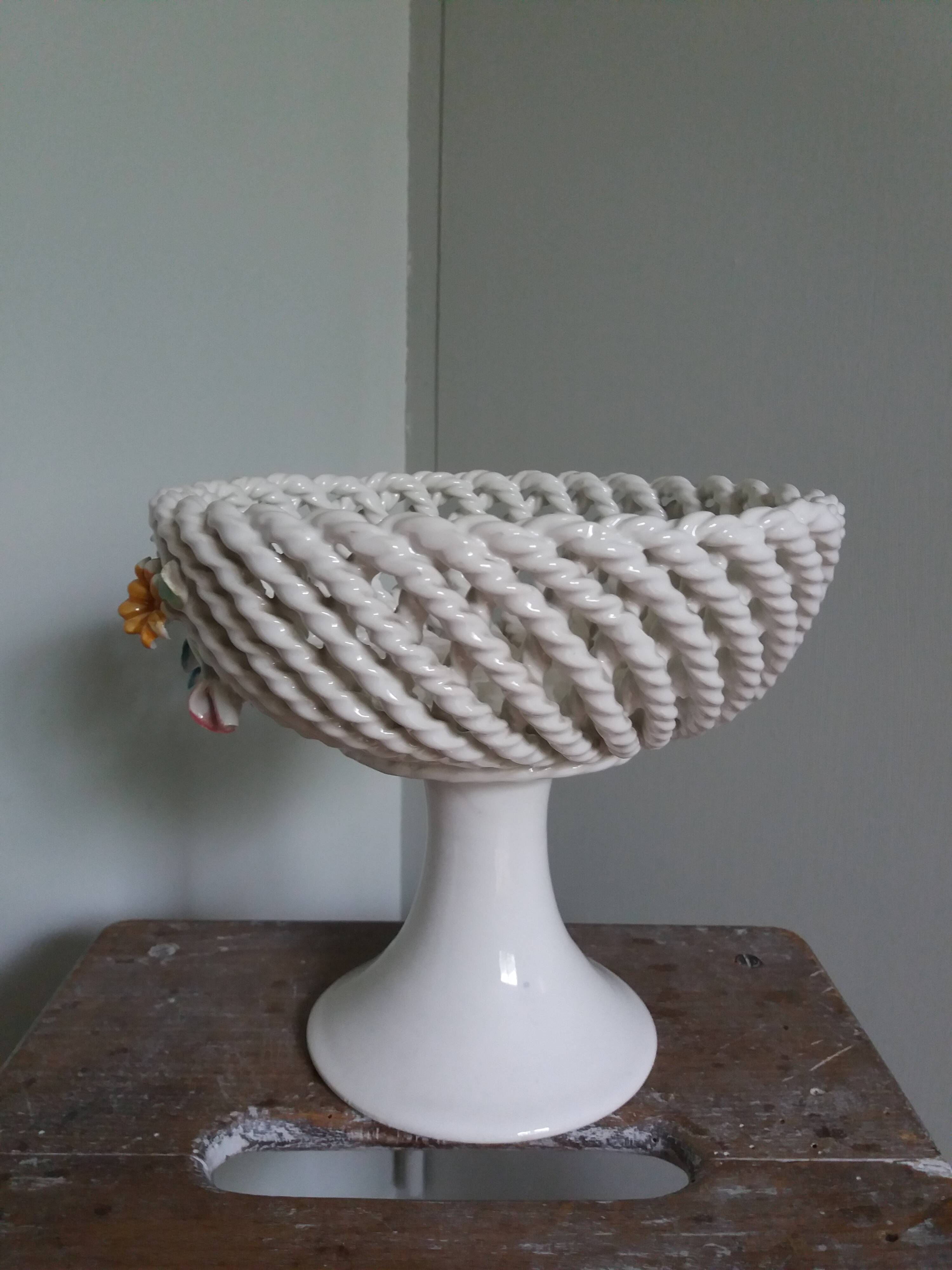 Cup on woven ceramic base with slip flowers