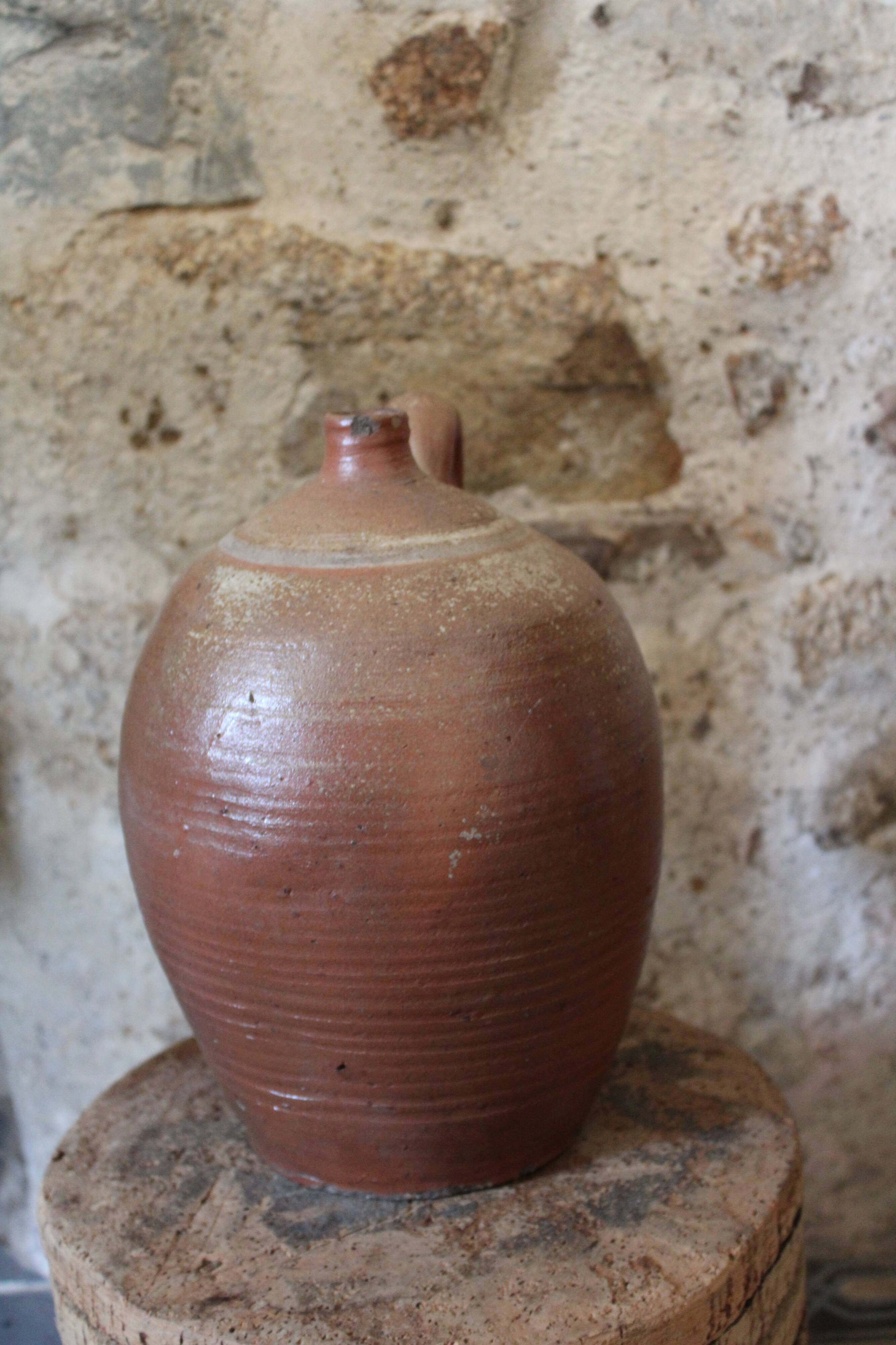 Vernified sandstone oil jar with handle