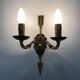 Pair of double-light Empire style arrow wall lights in bronze. Early 20th century