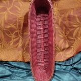Old bread basket for baguette or red banneton in woven wicker