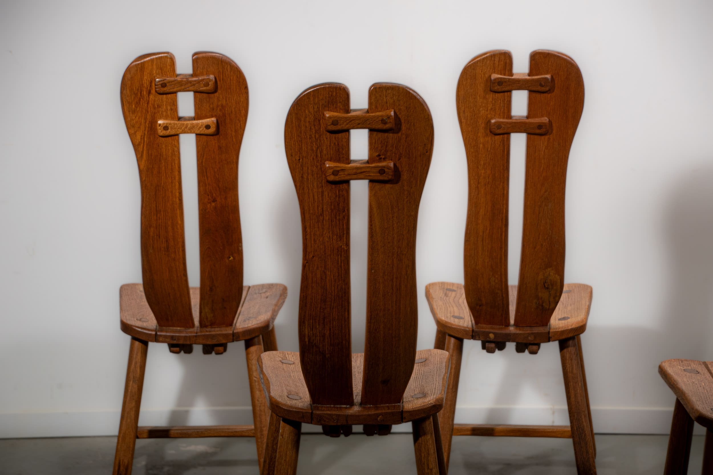 De Puydt brutalist dining chairs in solid oak. Circa 1970.