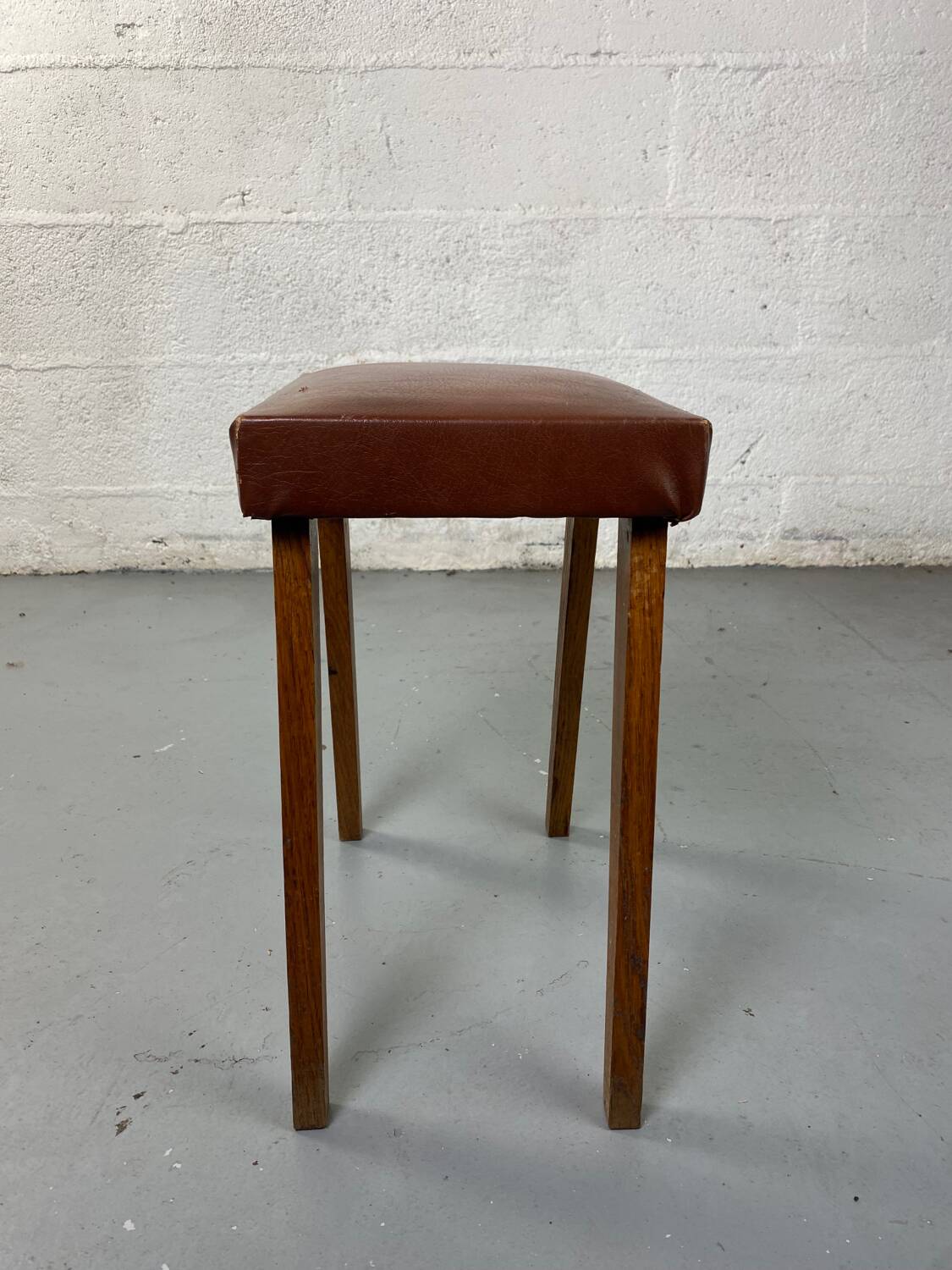 Small stool or footrest in wood and leather
