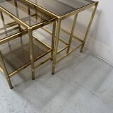 Set of three nesting tables in brass and smoked glass, 20th century
