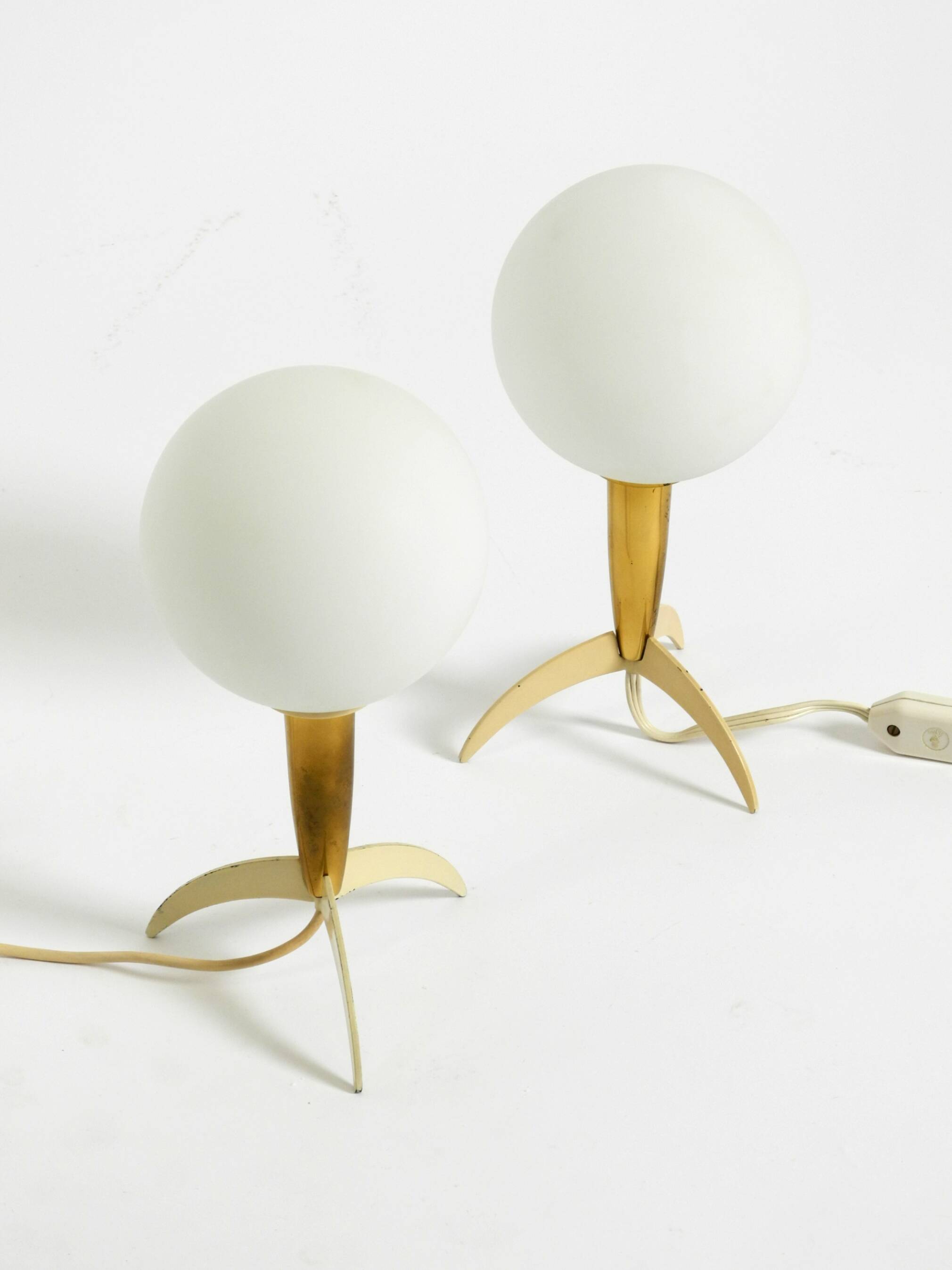 Two Mid-Century Modern rocket table lamps in brass and glass