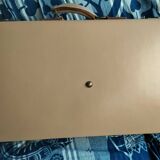 Old leather suitcase with its protective cover
