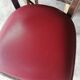 Set of 19 vintage wooden bistro chairs with red faux leather.