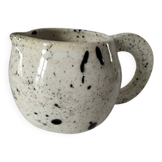 Small speckled ceramic jug in a vintage workshop style.