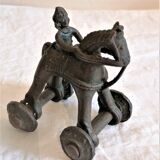Old child's toy. Horse with bronze wheels. Ethnic object.