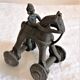 Old child's toy. Horse with bronze wheels. Ethnic object.