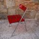 Red Plexiglas folding chair