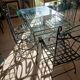 Glass table and wrought iron chairs