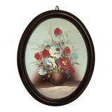 Oval painting of a bouquet of flowers, oil on panel.