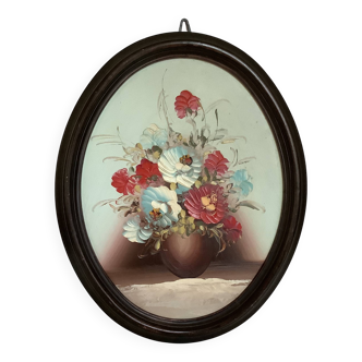 Oval painting of a bouquet of flowers, oil on panel.