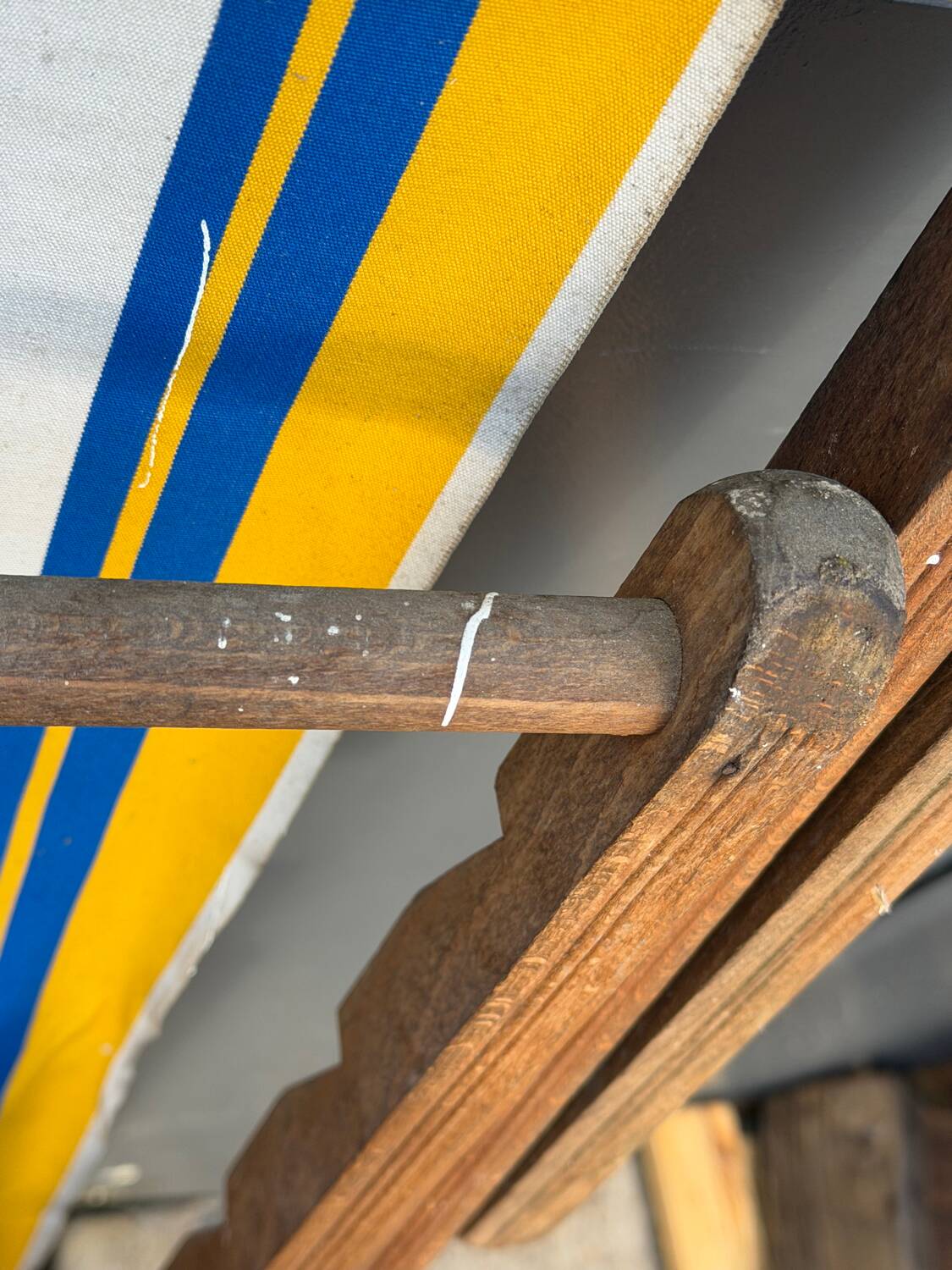 Vintage deck chair with blue and yellow striped fabric, original patina.