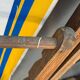 Vintage deck chair with blue and yellow striped fabric, original patina.