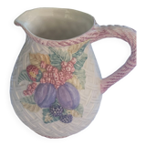 Glazed ceramic slip jug with vintage basket and fruit motif